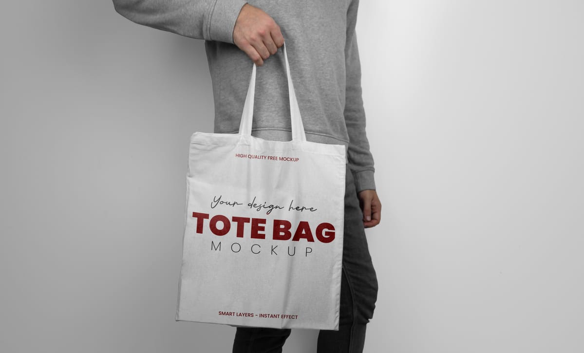 mockup of model holding a white tote bag